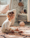 Kid play on moroccan handmade rug