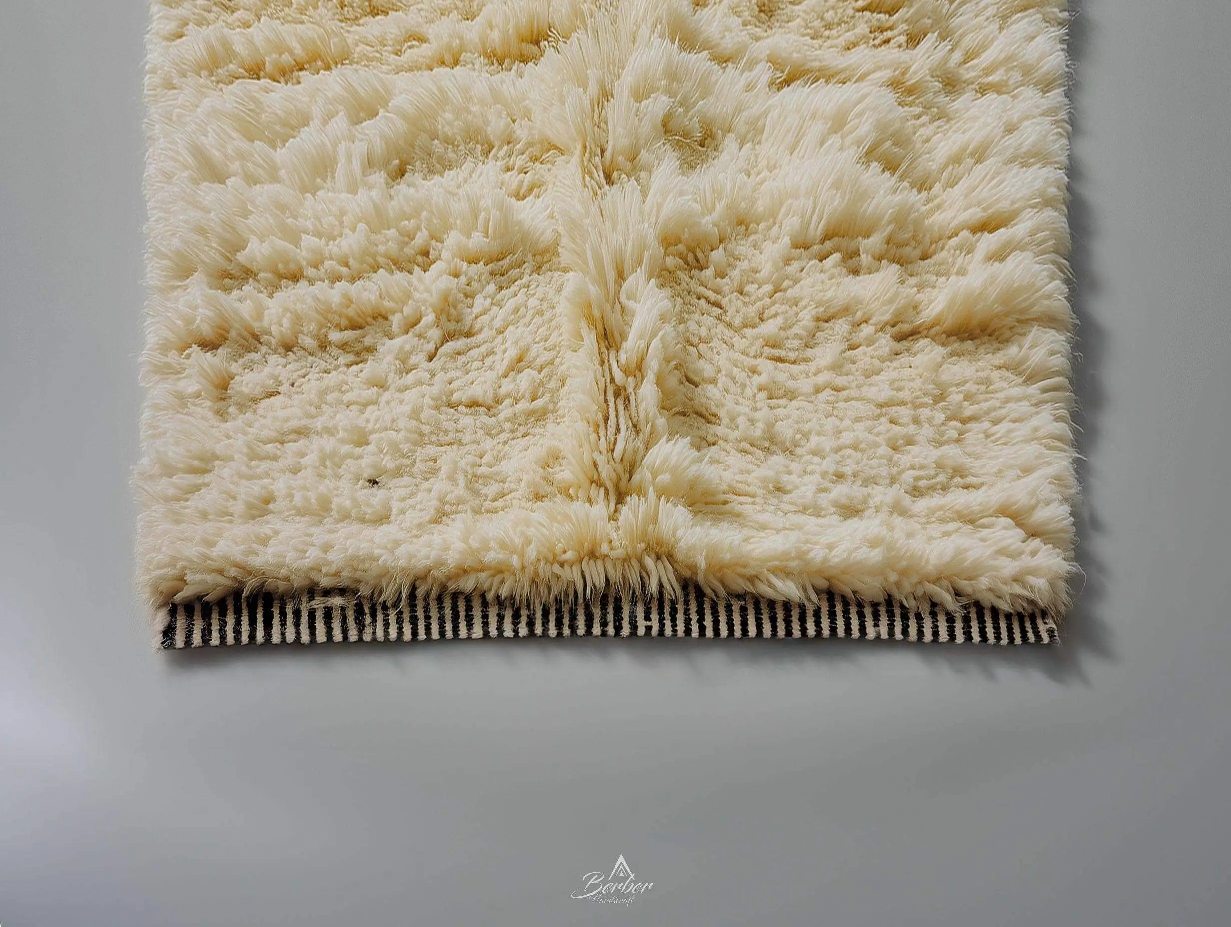 Beige textured moroccan rug on a plain background without tassels