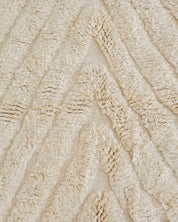 Close-up of textured beige fabric with wavy pattern