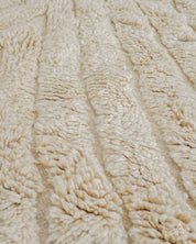 Close-up of textured beige fabric with a subtle pattern