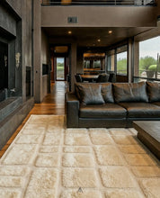 A textured invory Moroccan wool rug sitting on a bold style living room
