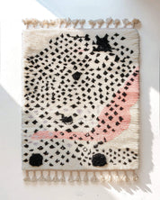 Hand-Knotted Moroccan rug with dotted black and pink design on a white background
