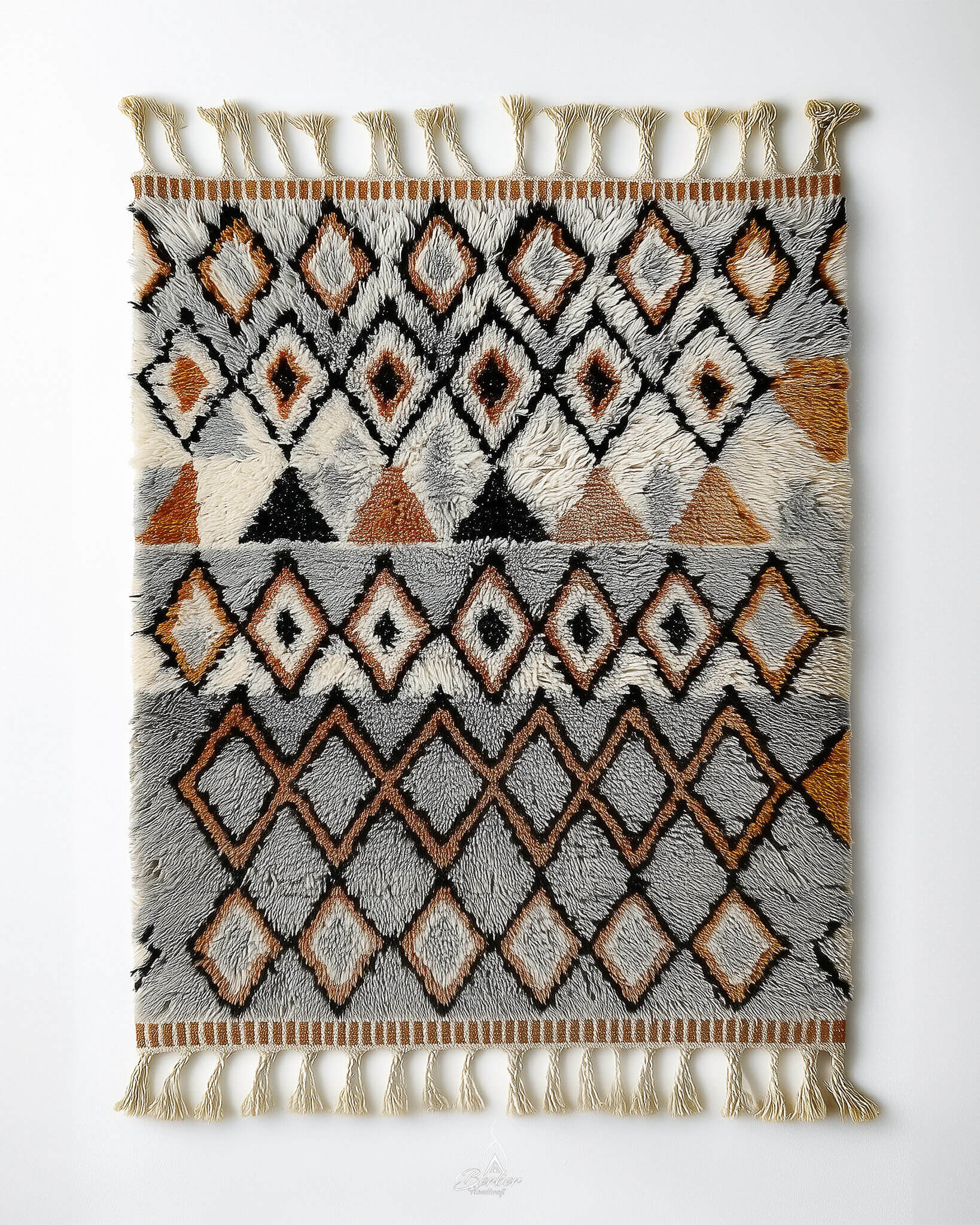 Handmade Moroccan rug with grey geometric pattern in vintage style and tassels on a white background