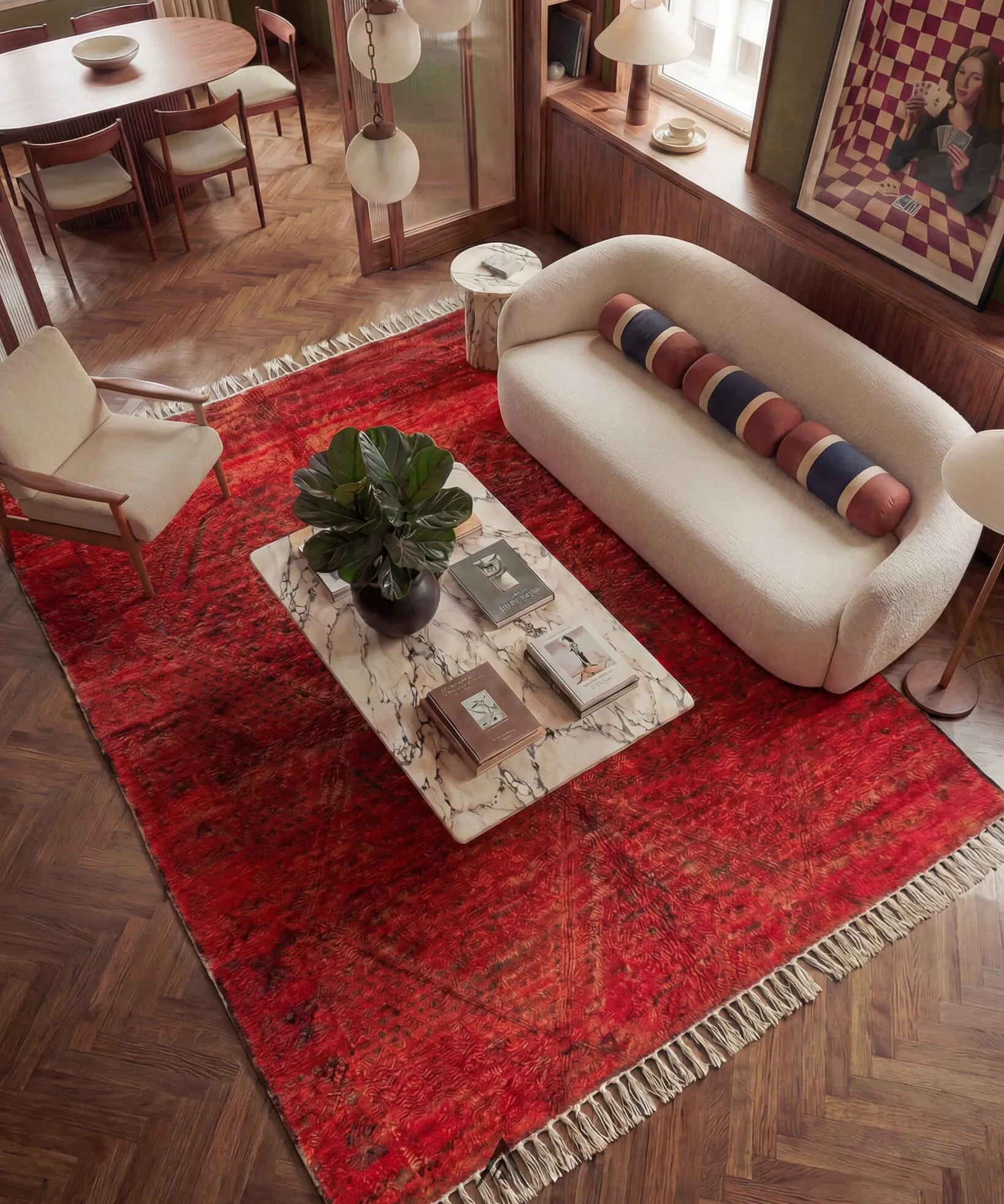 Living room with a red vintage moroccan rug, white sofa, and decorative items.