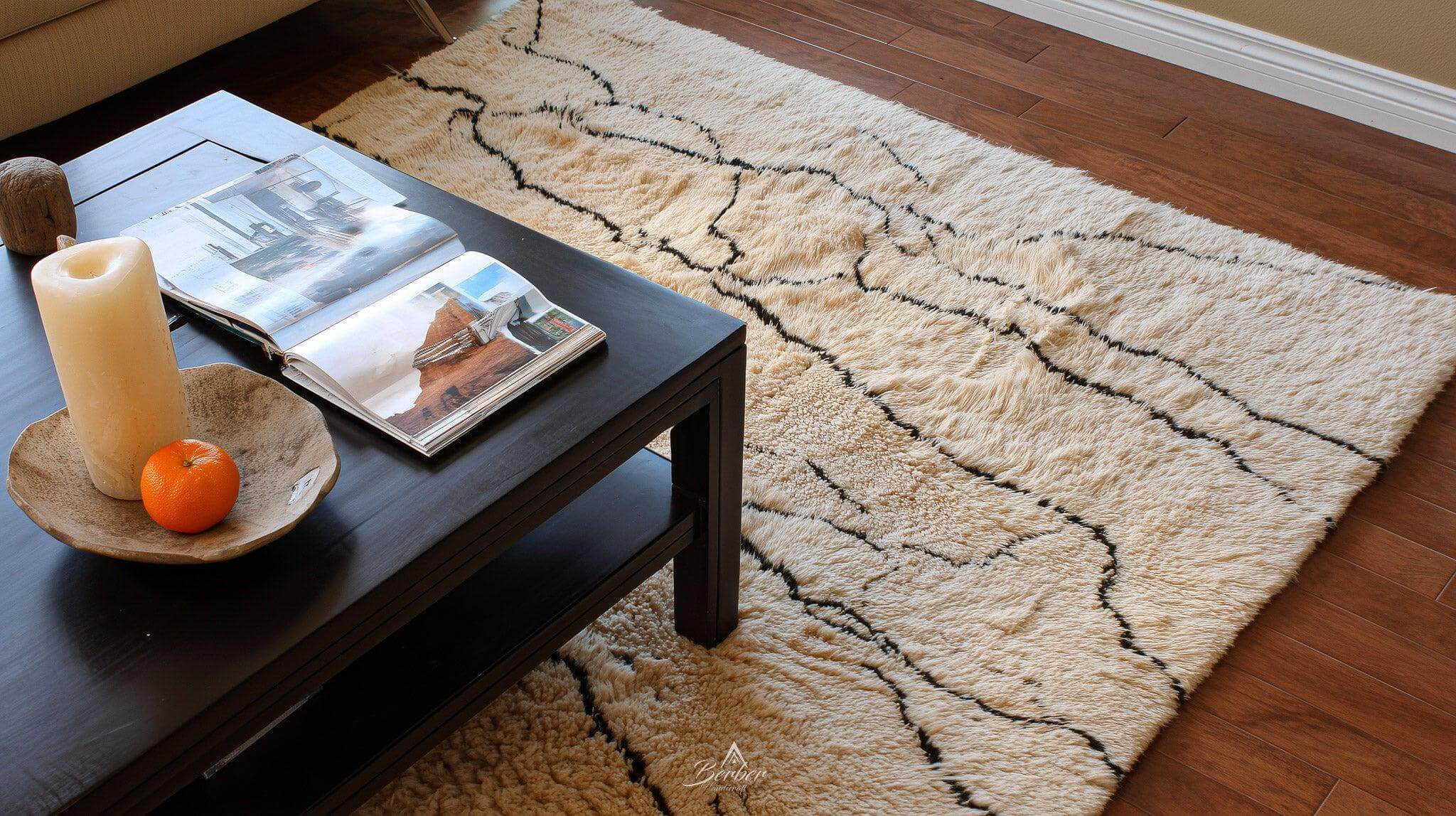 Ultra-minimal_room_pale_walls_only_a_handknotted-rug-Berber Handicraft