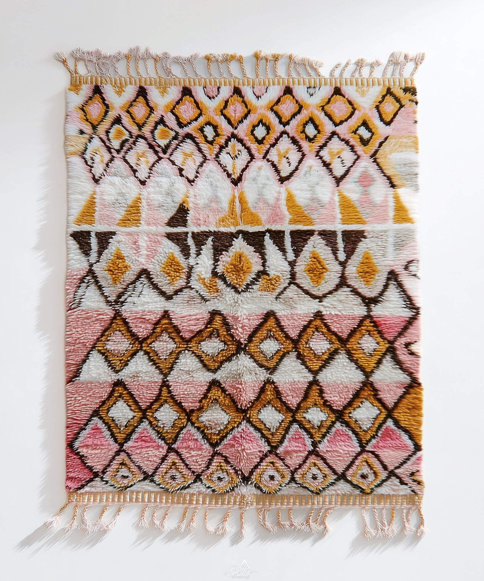 Decorative pink Moroccan rug with geometric pattern on a white background