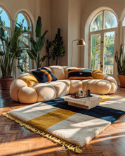Modern living room with a sectional sofa, colorful pillows, and a patterned yellow moroccan rug.